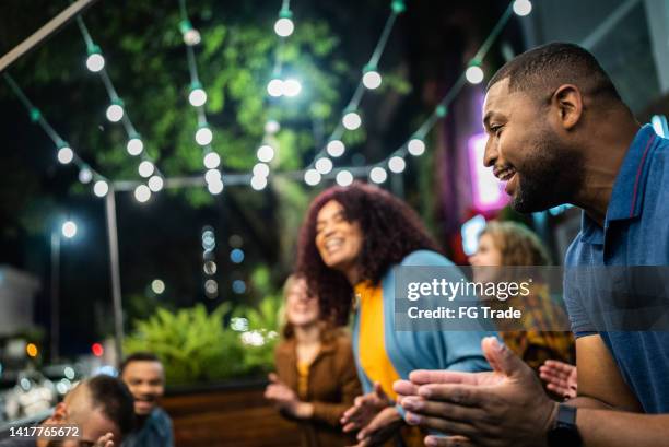 friends having a fun outdoors - straatfeest stockfoto's en -beelden