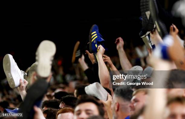 Leeds United fans show their support by taking their shoes off during the Carabao Cup Second Round match between Leeds United and Barnsley at Elland...