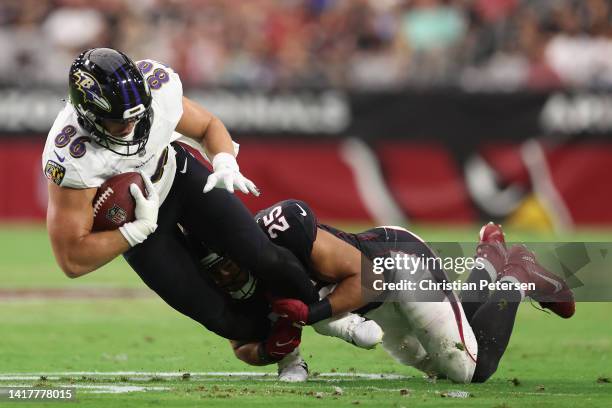 Tight end Nick Boyle of the Baltimore Ravens is tackled by linebacker Zaven Collins of the Arizona Cardinals during the NFL preseason game at State...