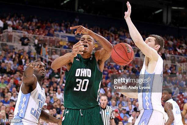 Reggie Keely of the Ohio Bobcats loses the ball as he drives in the first half against P.J. Hairston and Tyler Zeller of the North Carolina Tar Heels...