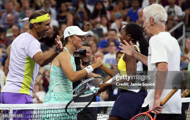 Iga Swiatek of Poland and Rafael Nadal of Spain shake hands with John McEnroe and Coco Gauff during Tennis Plays For Peace, exhibition matches to...