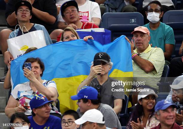 Fans hold a Ukranian flag during the Tennis Plays For Peace exhibition matches to benefit Ukraine at USTA Billie Jean King National Tennis Center on...