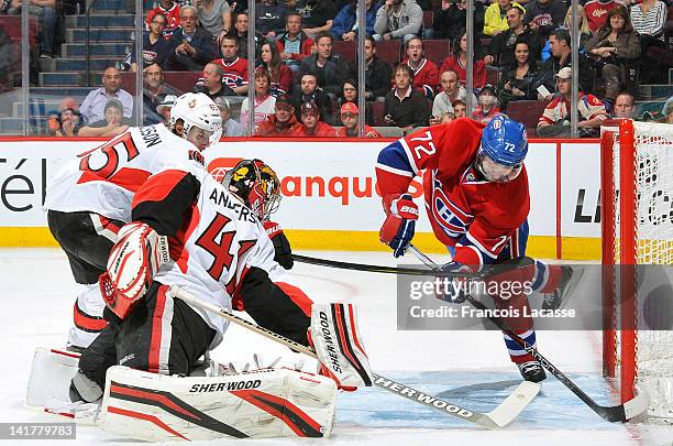 Erik Cole of the Montreal Canadiens slides the puck in the net behind goaltender Craig Anderson the Ottawa Senators during the NHL game on March 23,...