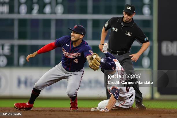 Jose Altuve of the Houston Astros is tagged out at second by Carlos Correa of the Minnesota Twins during the third inning at Minute Maid Park on...