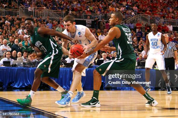 Tyler Zeller of the North Carolina Tar Heels attempts to control the ball in the second half against Ricardo Johnson and Reggie Keely of the Ohio...