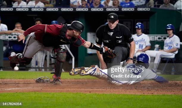 Kyle Isbel of the Kansas City Royals scores on a bunt off the bat of Nicky Lopez against catcher Carson Kelly of the Arizona Diamondbacks in the...