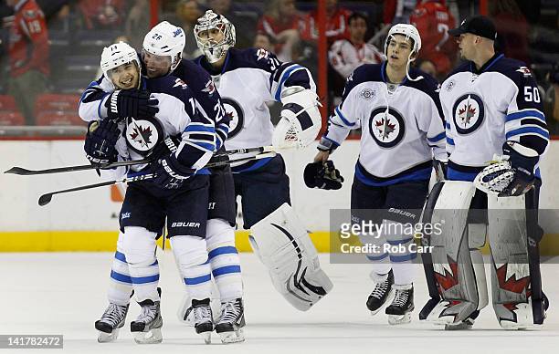 Tim Stapleton of the Winnipeg Jets is congratulated by teammate Blake Wheeler after scoring the game winning goal in overtime to defeat the...