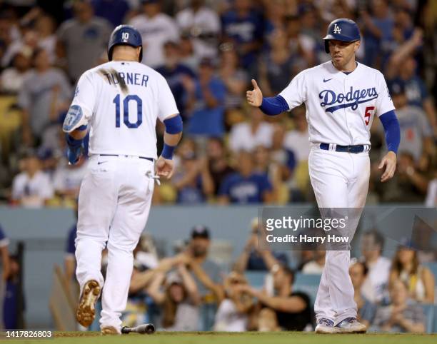 Freddie Freeman and Justin Turner of the Los Angeles Dodgers celebrates their runs from a Joey Gallo double, to take an 8-2 lead over the Milwaukee...