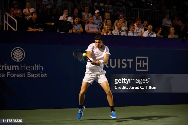 Jack Draper of Great Britain returns a shot from Dominic Thiem of Austria during their third round match on day five of the Winston-Salem Open at...