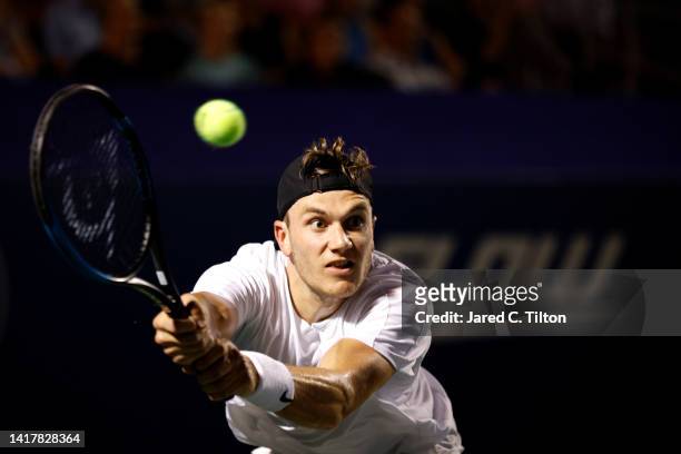 Jack Draper of Great Britain returns a shot from Dominic Thiem of Austria during their third round match on day five of the Winston-Salem Open at...