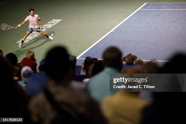 Dominic Thiem of Austria returns a shot from Jack Draper of Great Britain during their third round match on day five of the Winston-Salem Open at...