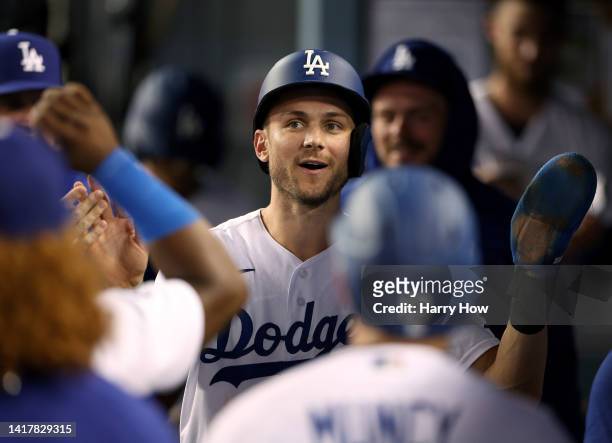 Trea Turner of the Los Angeles Dodgers celebrates his run in the dugout, to take a 6-2 lead over the Milwaukee Brewers, during the fourth inning at...