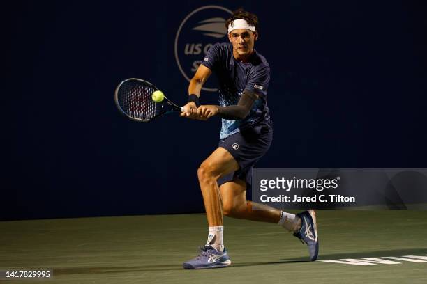 Marc-Andrea Huesler of Switzerland returns a shot from Ilya Ivashka of Belarus during their third round match on day five of the Winston-Salem Open...