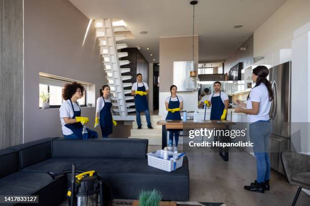 group of professional cleaners getting a brief on their job - janitorial supplies stock pictures, royalty-free photos & images