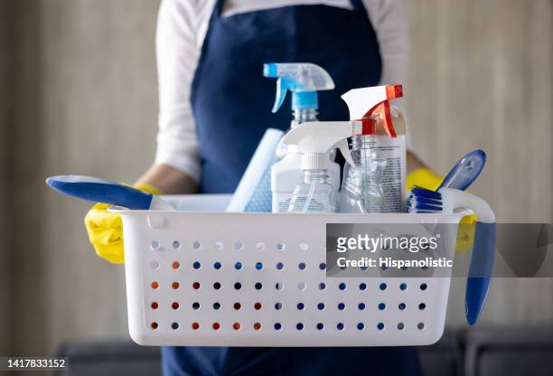 close-up on a cleaner holding a basket of cleaning products - serviços de limpeza imagens e fotografias de stock