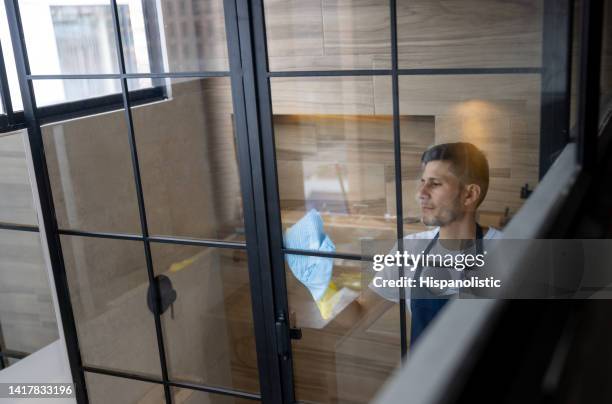 professional cleaner cleaning the glass door in the bathroom - commercial cleaning stock pictures, royalty-free photos & images