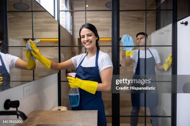 happy professional cleaners cleaning a bathroom at an apartment - cleaner smiling stock pictures, royalty-free photos & images