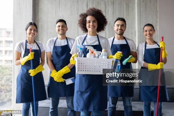 team of professional cleaners working at an apartment - cleaning crew stock pictures, royalty-free photos & images