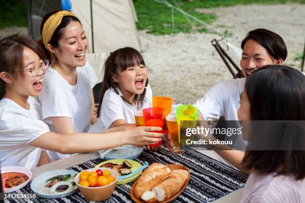 happy family of five toasting at the campsite. - japan 12 years girl stock pictures, royalty-free photos & images