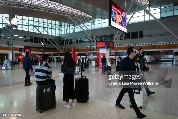 People arrive to check-in at the Qantas domestic terminal at Sydney Airport on August 25, 2022 in Sydney, Australia. Qantas Group posted a loss of...