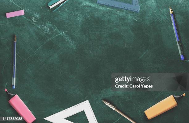 back to school concept.school supplies top view in chalkboard - pizarra fotografías e imágenes de stock