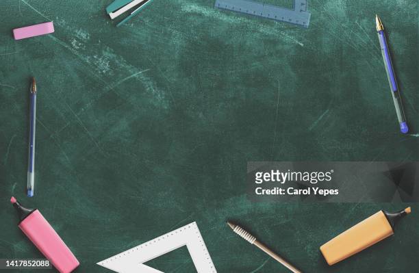back to school concept.school supplies top view in chalkboard - schoolbord stockfoto's en -beelden
