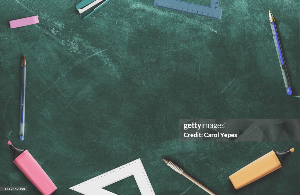 Back to school concept.school supplies top view in chalkboard