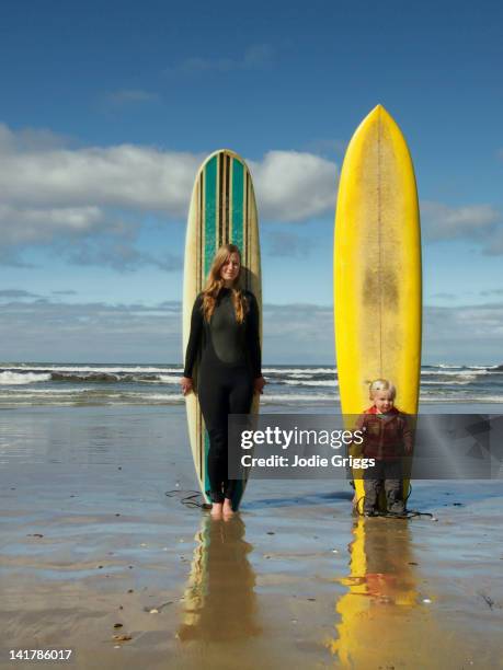 adult & child standing with surfboards - bruny island stock pictures, royalty-free photos & images