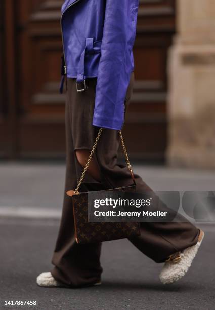 Sonia Lyson is seen wearing Louis Vuitton monogramm brown clutch bag, Nakd fur slipper, Prada brown shades, Storets brown destroyed wide leg jogging...