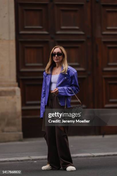 Sonia Lyson is seen wearing Louis Vuitton monogramm brown clutch bag, Nakd fur slipper, Prada brown shades, Storets brown destroyed wide leg jogging...