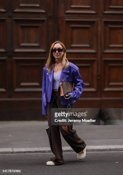 Sonia Lyson is seen wearing Louis Vuitton monogramm brown clutch bag, Nakd fur slipper, Prada brown shades, Storets brown destroyed wide leg jogging...
