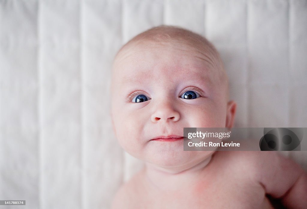 Infant boy with surprised face, portrait