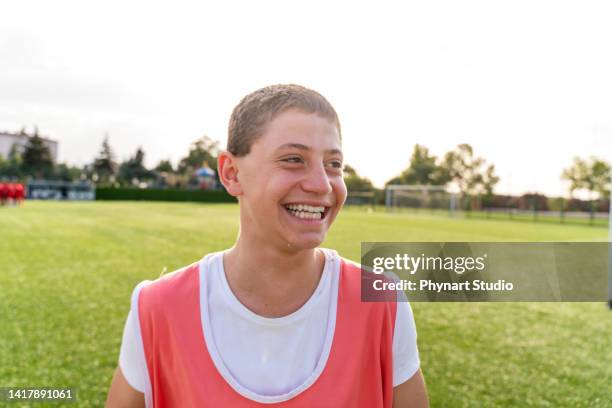 happy boy smiles after winning soccer game - junior achievement stock pictures, royalty-free photos & images