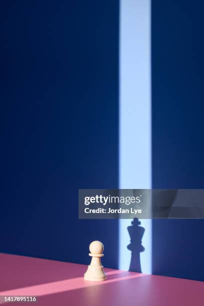 pawn chess piece with king shadow - chess icon stock pictures, royalty-free photos & images