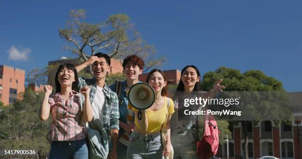 happy students speak with megaphone - asian loud hailer stock pictures, royalty-free photos & images