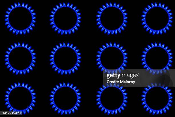 close-up of the blue gas flame on a gas stove. gas burning on a gas stove. - gas ring stock pictures, royalty-free photos & images