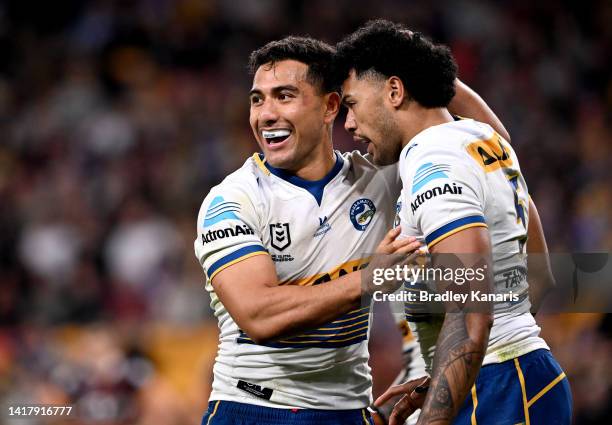 Will Penisini of the Eels celebrates with team mate Waqa Blake after scoring a try during the round 24 NRL match between the Brisbane Broncos and the...