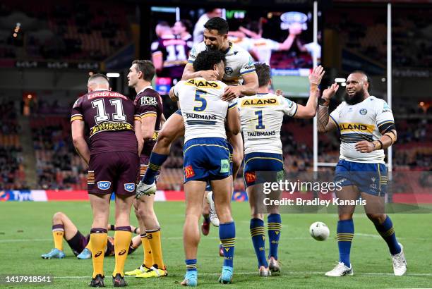 Waqa Blake of the Eels is congratulated by team mates after scoring a try during the round 24 NRL match between the Brisbane Broncos and the...