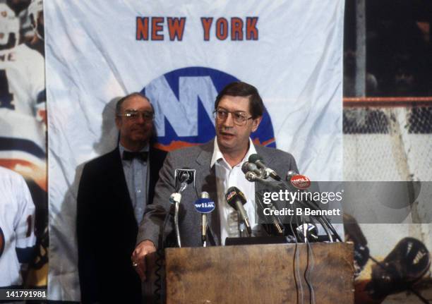 Head coach Al Arbour of the New York Islanders speaks at a press conference as general manager Bill Torrey looks on in March, 1984 at the Nassau...