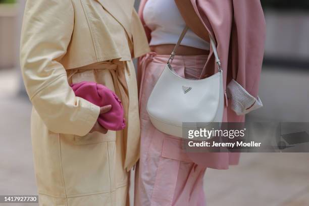 Lou Beyer wearing white Prada Cleo leather bag, creme yellow long by Aylin Koenig coat, white Acne Studios shirt and Julia Zwingenberg wearing...