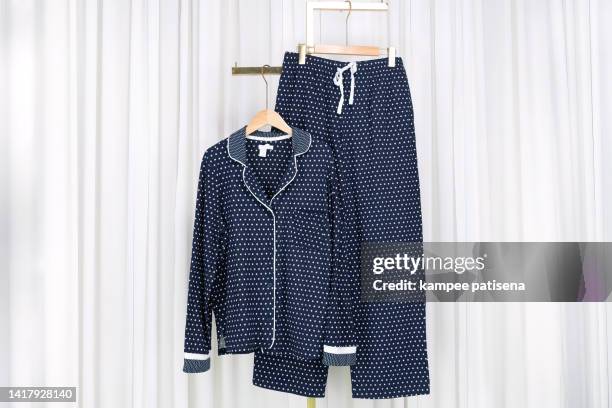 pajamas hanging in home - silk pajamas stock pictures, royalty-free photos & images