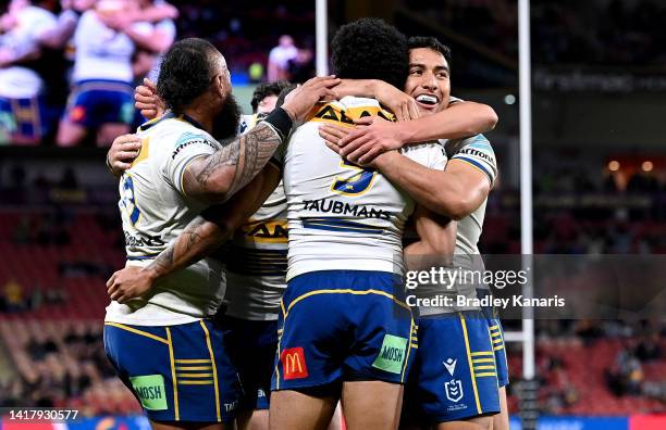 Waqa Blake of the Eels is congratulated by team mates after scoring a try during the round 24 NRL match between the Brisbane Broncos and the...