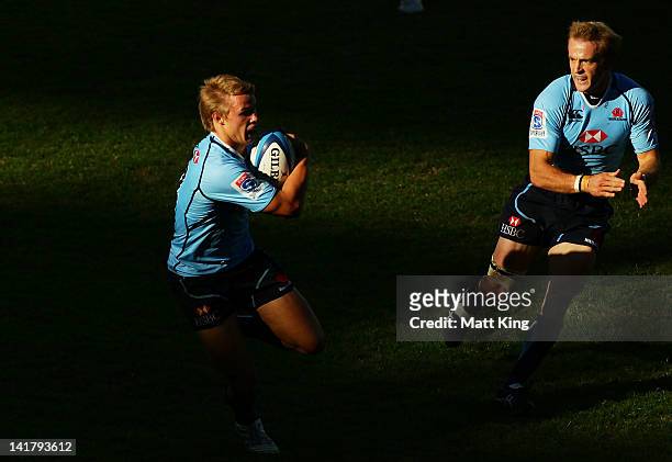 Tom Kingston of the Waratahs charges towards the line to score the final try with Sarel Pretorius in support during the round five Super Rugby match...