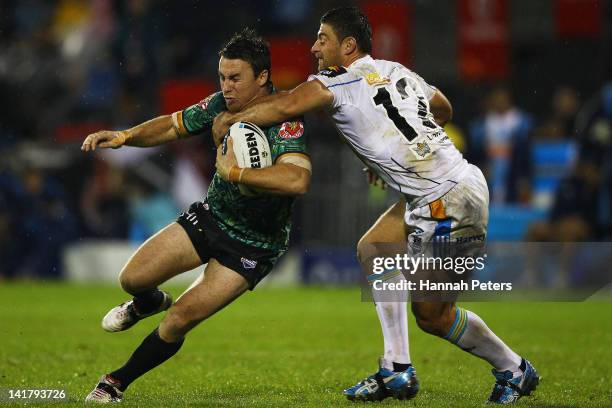 James Maloney of the Warriors is tackled by Mark Minichiello of the Titans during the round four NRL match between the New Zealand Warriors and the...