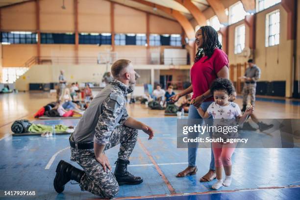 people in school gymnasium shelter - civilian stock pictures, royalty-free photos & images