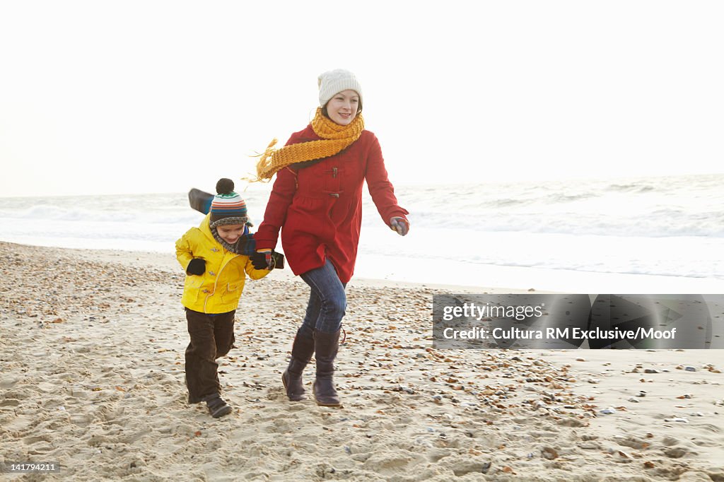 Mother and son bundled up on beach