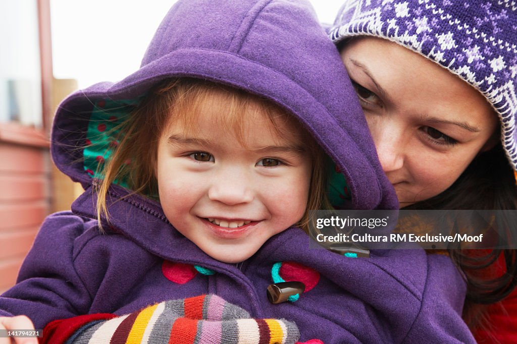 Close up of mother hugging daughter