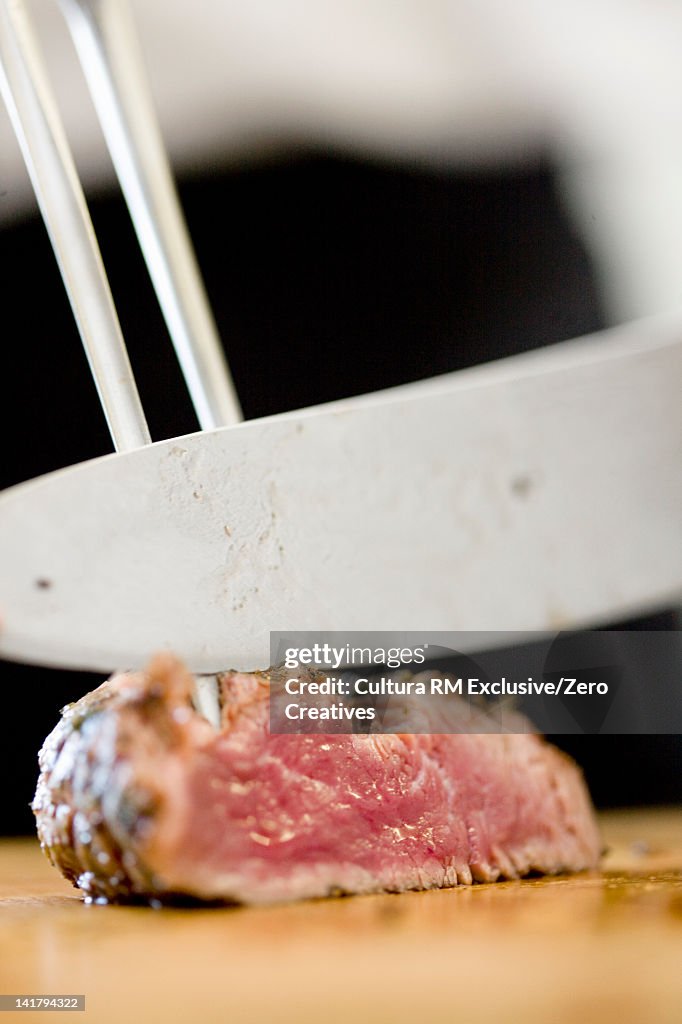 Close up of chef chopping meat