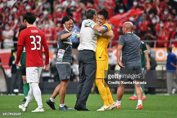 Shusaku Nishikawa of Urawa Red Diamonds is congratulated by head coach Ricardo Rodriguez after their penalty shootout victory in the AFC Champions...