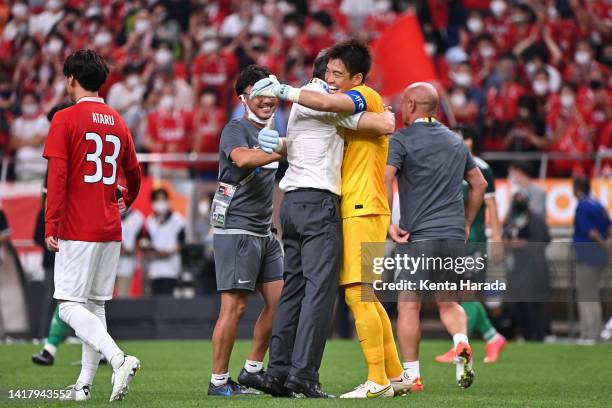 Shusaku Nishikawa of Urawa Red Diamonds is congratulated by head coach Ricardo Rodriguez after their penalty shootout victory in the AFC Champions...